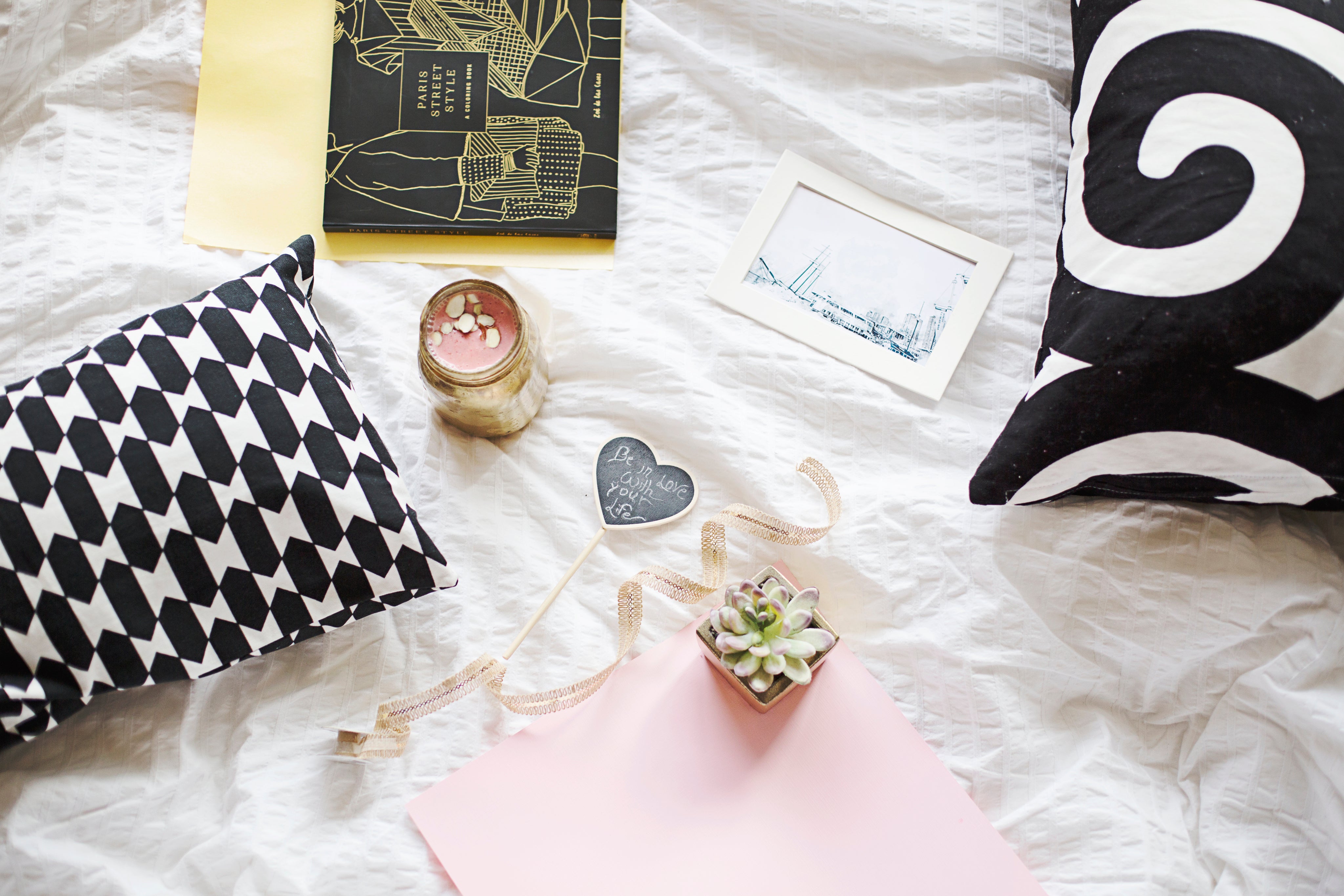 flatlay-of-books-with-plants-and-a-smoothie-on-a-white-sheet.jpg