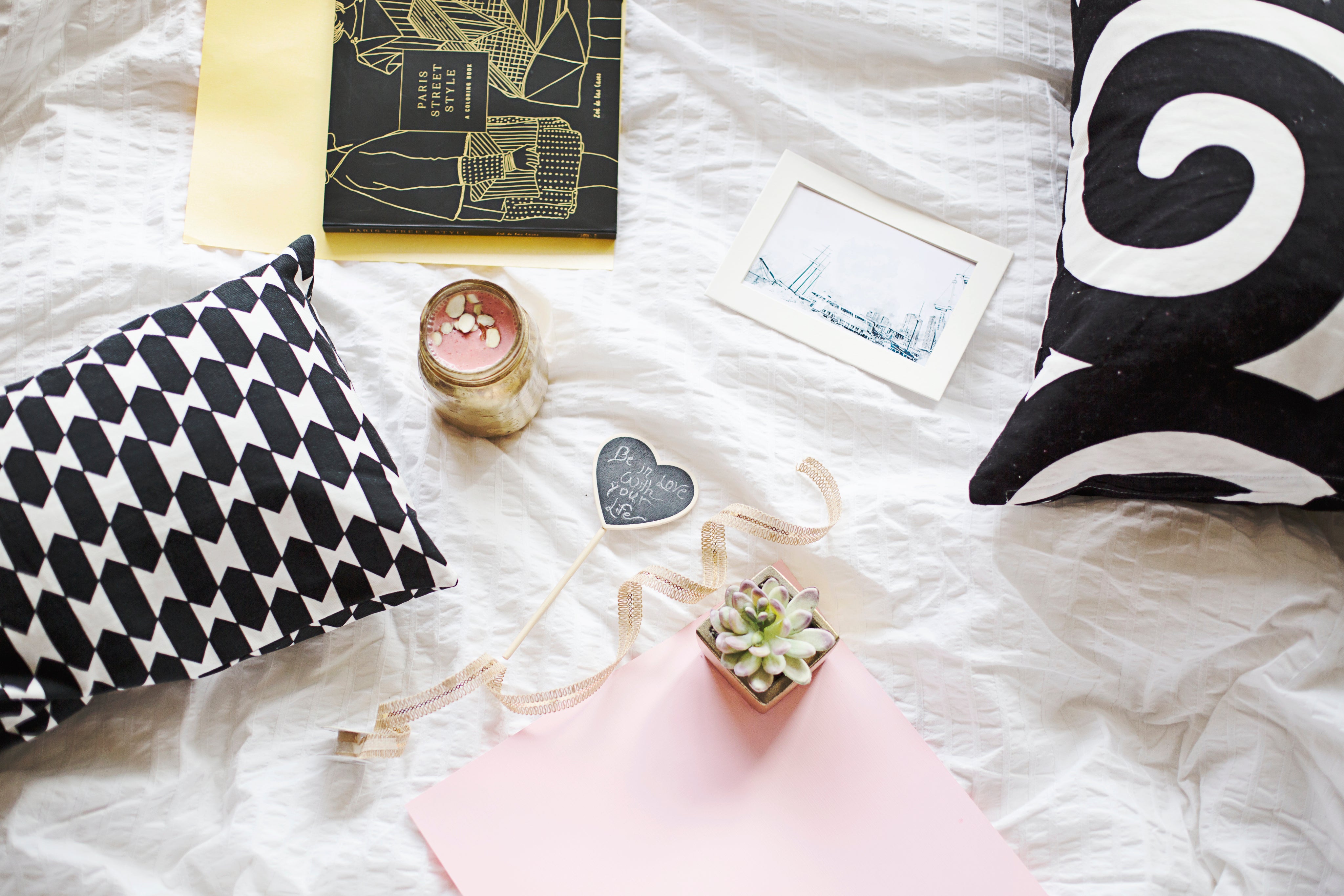 flatlay-of-books-with-plants-and-a-smoothie-on-a-white-sheet.jpg